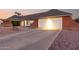 Charming single-story home with a brick accent, two-car garage and desert landscaping at 2259 E Ivy St, Mesa, AZ 85213