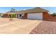 Charming single-story home with a brick accent, two-car garage and desert landscaping at 2259 E Ivy St, Mesa, AZ 85213