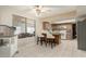 Bright kitchen with a breakfast bar and white chairs overlooking the living space at 2259 E Ivy St, Mesa, AZ 85213