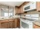 Kitchen features a tiled backsplash, granite countertops and white oven and microwave at 2259 E Ivy St, Mesa, AZ 85213