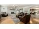Cozy living room with brick fireplace, wood floors, and comfortable seating arrangement at 2259 E Ivy St, Mesa, AZ 85213
