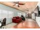 Spacious living room featuring a wood plank ceiling, ceiling fans and a comfortable red sofa at 2259 E Ivy St, Mesa, AZ 85213