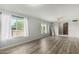 Bright living room features hard surface floors and large windows with white curtains at 2259 E Ivy St, Mesa, AZ 85213