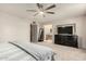 Spacious main bedroom with carpeted floors, a large bed, and ensuite bathroom access at 2259 E Ivy St, Mesa, AZ 85213