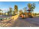 Community playground with various play structures, swings, and shaded seating areas at 2259 E Ivy St, Mesa, AZ 85213