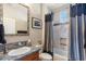 Well-lit bathroom with a granite countertop, shower/tub combo, and modern fixtures at 25943 N 84Th Dr, Peoria, AZ 85383