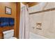 Neutral-toned bathroom with tile shower and granite accents, offering a clean and modern design at 25943 N 84Th Dr, Peoria, AZ 85383