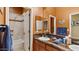 Bathroom with wood cabinets, granite countertops, and a shower-tub combo at 25943 N 84Th Dr, Peoria, AZ 85383