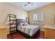 Bedroom with hardwood floors, plantation shutters, and bright natural light at 25943 N 84Th Dr, Peoria, AZ 85383