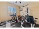 Home gym space with treadmills, a multi-station machine, and a mounted television at 25943 N 84Th Dr, Peoria, AZ 85383