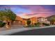 Charming single-story home featuring a well-maintained lawn, desert landscaping, and two car garage at 25943 N 84Th Dr, Peoria, AZ 85383