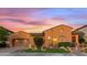 Charming single-story home featuring a well-maintained lawn, desert landscaping, and two car garage at 25943 N 84Th Dr, Peoria, AZ 85383