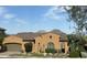 Charming single-story home featuring a well-maintained lawn, desert landscaping, and two car garage at 25943 N 84Th Dr, Peoria, AZ 85383