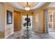 Elegant foyer with decorative table, stone floors, and arched ceilings creates a grand entrance at 25943 N 84Th Dr, Peoria, AZ 85383