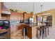Open-concept kitchen with stainless steel appliances, granite countertops, and large center island at 25943 N 84Th Dr, Peoria, AZ 85383
