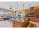 Spacious kitchen and living area with granite countertops, stainless steel appliances, and tile floors at 25943 N 84Th Dr, Peoria, AZ 85383