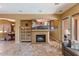 Cozy living room with fireplace, television, and tile floors with neutral paint at 25943 N 84Th Dr, Peoria, AZ 85383