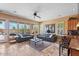 Open-concept living room with a breakfast bar, tile floors, large windows, and neutral paint at 25943 N 84Th Dr, Peoria, AZ 85383