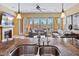 Open-concept living room with a fireplace, stylish sofas, and seamless indoor-outdoor flow at 25943 N 84Th Dr, Peoria, AZ 85383