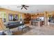 Cozy living room adjacent to a kitchen island, offering pool views and comfortable seating at 25943 N 84Th Dr, Peoria, AZ 85383