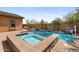 Aerial view of in-ground pool with attached spa, mature trees, and desert landscaping at 25943 N 84Th Dr, Peoria, AZ 85383
