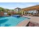 Inviting pool area with a spa, covered patio, and palm trees, perfect for outdoor entertaining at 25943 N 84Th Dr, Peoria, AZ 85383