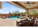 Inviting backyard pool and spa with covered patio and mountain views, perfect for relaxation and entertaining at 25943 N 84Th Dr, Peoria, AZ 85383