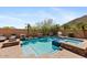 Resort-style pool with spa, waterfall features, and lush landscaping create a relaxing backyard retreat at 25943 N 84Th Dr, Peoria, AZ 85383