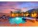 Inviting backyard oasis with pool, spa, lush landscaping, fire pit, and privacy fence at 25943 N 84Th Dr, Peoria, AZ 85383