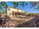 Backyard view of the home featuring a covered patio and large yard, with a privacy fence at 3133 N Medallion Ct, Casa Grande, AZ 85122