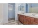 Bathroom featuring double sinks, wood-look flooring, and a bright color scheme at 3133 N Medallion Ct, Casa Grande, AZ 85122