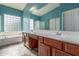 Turquoise bathroom featuring double sinks, wood-look flooring, and a separate shower at 3133 N Medallion Ct, Casa Grande, AZ 85122