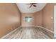 Spacious bedroom featuring wood-look flooring, ceiling fan, and ample natural light at 3133 N Medallion Ct, Casa Grande, AZ 85122