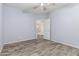 Bedroom featuring neutral walls, wood-look floors, closet and entry door at 3133 N Medallion Ct, Casa Grande, AZ 85122