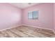 Bedroom with painted walls, window, and wood-look floors at 3133 N Medallion Ct, Casa Grande, AZ 85122