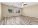 Bedroom with wood-look floors and natural light from two windows at 3133 N Medallion Ct, Casa Grande, AZ 85122