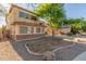 Charming two-story home featuring stucco siding, shutters, and a well-maintained front yard at 3133 N Medallion Ct, Casa Grande, AZ 85122