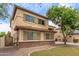 Attractive two-story home with a light tan exterior, brick accents, and desert landscaping at 3133 N Medallion Ct, Casa Grande, AZ 85122