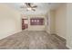 Spacious living room featuring modern wood-look flooring, a ceiling fan, and neutral-toned walls at 3133 N Medallion Ct, Casa Grande, AZ 85122
