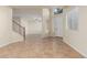 Spacious living room with tile floors and open layout leading to the entryway with lots of light at 3133 N Medallion Ct, Casa Grande, AZ 85122