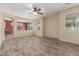 Bright living room boasts tile flooring, a ceiling fan, and ample natural light from windows at 3133 N Medallion Ct, Casa Grande, AZ 85122