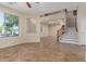 Spacious living room with tile floors, a high ceiling, lots of natural light and a staircase at 3133 N Medallion Ct, Casa Grande, AZ 85122