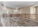 Spacious loft featuring wood-look floors and railing at 3133 N Medallion Ct, Casa Grande, AZ 85122