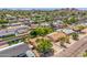An aerial view of a neighborhood with many homes surrounded by greenery and mountains in the background at 355 E Fillmore St, Tempe, AZ 85288