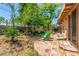 Spacious backyard with a tiled patio, mature trees, and comfortable seating at 355 E Fillmore St, Tempe, AZ 85288