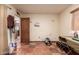 Bright basement with terracotta tiled floors, storage, and door to kitchen at 355 E Fillmore St, Tempe, AZ 85288