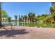 A scenic pond view with lush green foliage, palm trees, and a bench for enjoying the serene water at 355 E Fillmore St, Tempe, AZ 85288