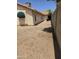Side backyard with desert landscaping, exterior door, and partial view of block fence at 3601 E Taro Ln, Phoenix, AZ 85050