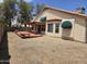 Backyard featuring covered patio, wooden deck, desert landscaping and block fence at 3601 E Taro Ln, Phoenix, AZ 85050