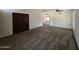 Spacious carpeted bedroom with ceiling fan and view to next room through arched opening at 3601 E Taro Ln, Phoenix, AZ 85050